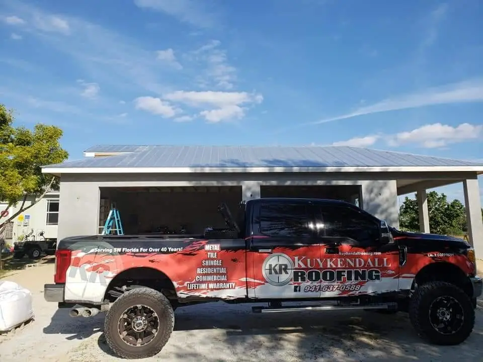 Kuykendall Roofing crew replacing an old roof on a Florida home, showing the tear-off phase during a complete roof replacement process