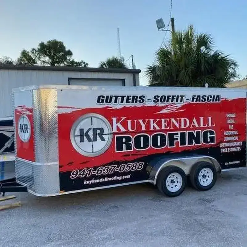 Kuykendall Roofing trailer labeled with “Gutters • Soffit • Fascia” parked on-site, ready for seamless gutter installation services