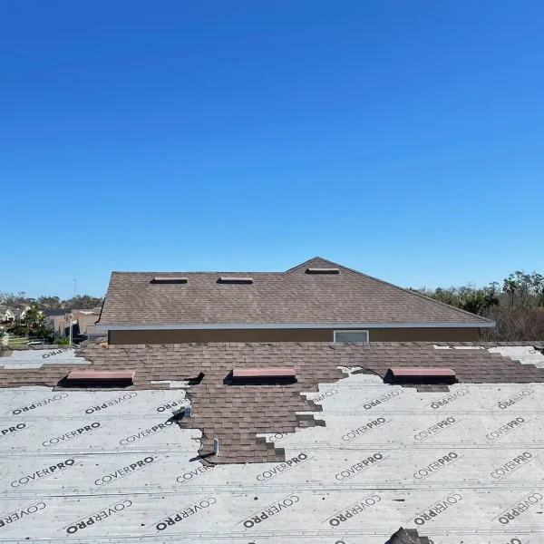 Hurricane Ian Roof Damage Wide view of a home with missing and curling shingles, used during Kuykendall Roofing’s storm damage inspection to identify areas needing repair