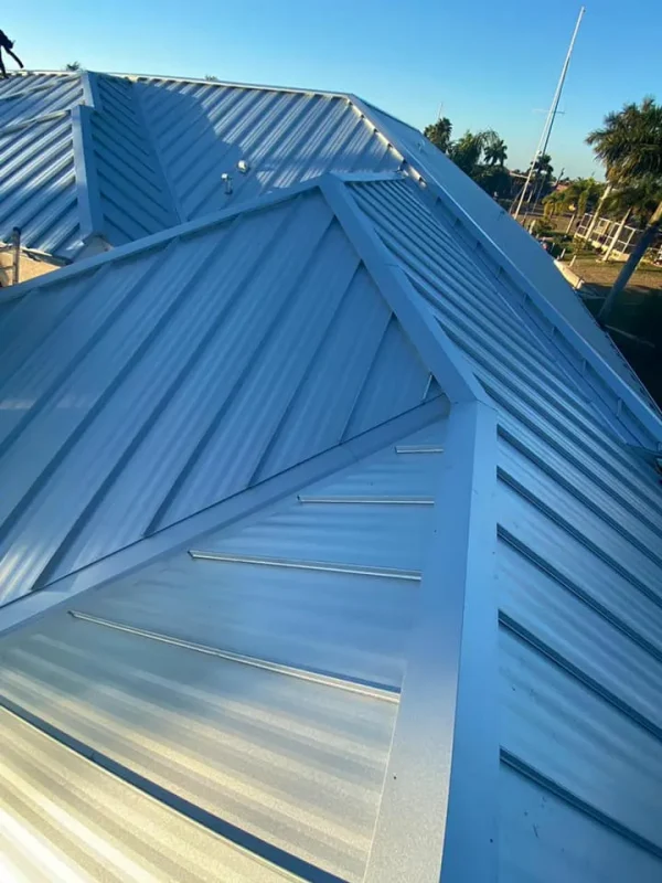 Residential-Metal-Roof-3 Close-up of interlocking metal roof panels in sunlight, installed by Kuykendall Roofing as part of their long-lasting roof material options