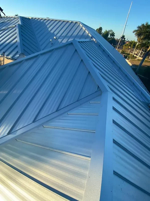 Close-up of interlocking metal roof panels in sunlight, installed by Kuykendall Roofing as part of their long-lasting roof material options
